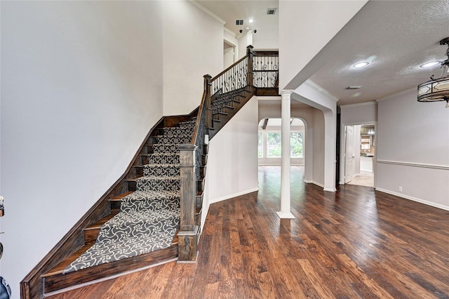 21814 Canton Pass Ln, Katy, TX 77450 - stairway with ornamental molding, wood finished floors, baseboards, arched walkways, and a textured ceiling