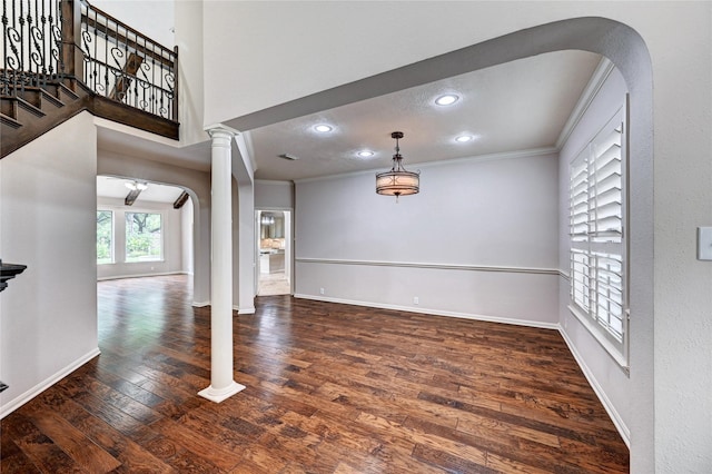 21814 Canton Pass Ln, Katy, TX 77450 - unfurnished living room featuring crown molding, arched walkways, wood finished floors, baseboards, and decorative columns
