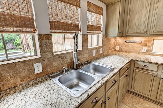 21814 Canton Pass Ln, Katy, TX 77450 - kitchen featuring a sink, tasteful backsplash, and light stone counters