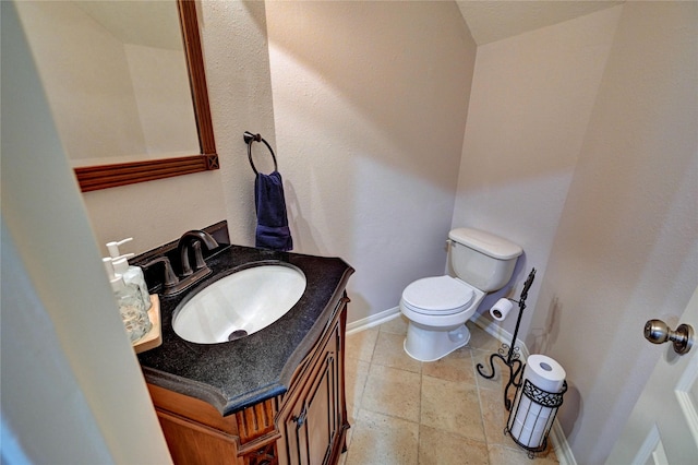 21814 Canton Pass Ln, Katy, TX 77450 - bathroom featuring baseboards, toilet, vanity, and stone tile flooring