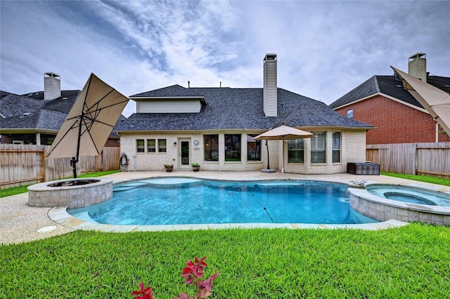 21814 Canton Pass Ln, Katy, TX 77450 - view of swimming pool featuring a pool with connected hot tub, a patio, and a fire pit