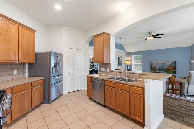 4613 Meridian Park Dr, Pearland, TX 77584 - kitchen featuring stainless steel appliances, a sink, arched walkways, open floor plan, and a ceiling fan