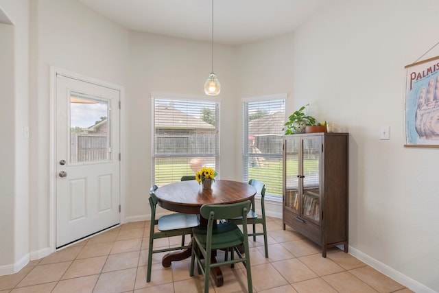 4613 Meridian Park Dr, Pearland, TX 77584 - dining area featuring high vaulted ceiling, light tile patterned floors, and baseboards