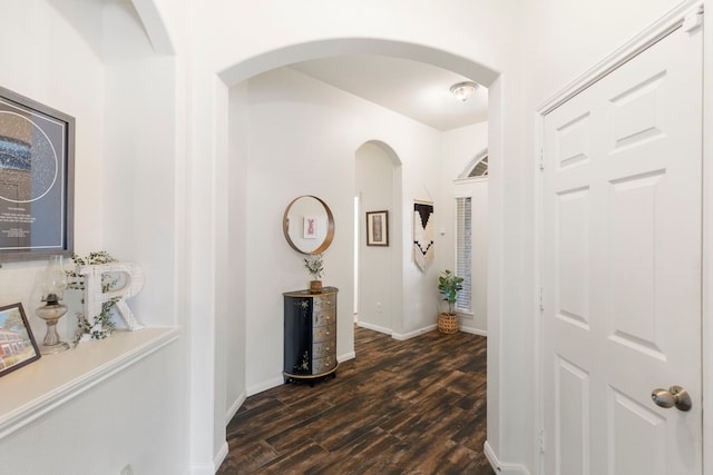 4613 Meridian Park Dr, Pearland, TX 77584 - hallway with dark wood-style flooring, arched walkways, and baseboards