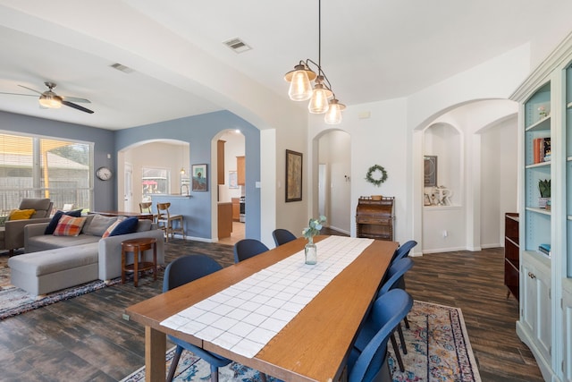 4613 Meridian Park Dr, Pearland, TX 77584 - dining space with ceiling fan, dark wood-style flooring, baseboards, and arched walkways