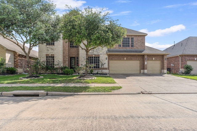 24914 Hazel Ranch Dr, Katy, TX 77494 - view of front facade with driveway, a garage, brick siding, and stone siding