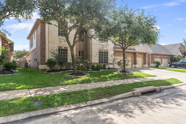 24914 Hazel Ranch Dr, Katy, TX 77494 - view of front of house with brick siding, concrete driveway, a garage, and a front lawn