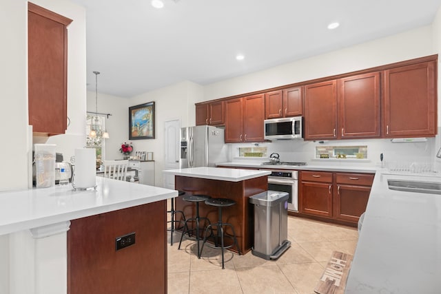 24914 Hazel Ranch Dr, Katy, TX 77494 - kitchen featuring stainless steel appliances, a breakfast bar, a sink, light countertops, and recessed lighting