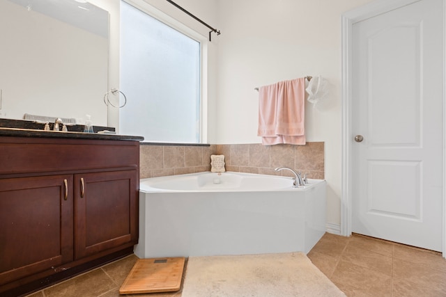 24914 Hazel Ranch Dr, Katy, TX 77494 - full bathroom with vanity, a garden tub, and tile patterned floors