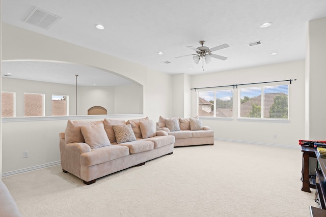 24914 Hazel Ranch Dr, Katy, TX 77494 - living room with carpet floors, arched walkways, recessed lighting, baseboards, and ceiling fan