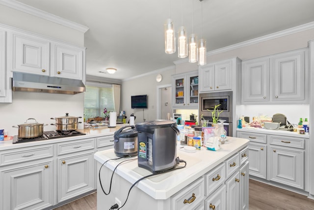 548 Cascade St, Bellaire, TX 77401 - kitchen featuring under cabinet range hood, gas cooktop, ornamental molding, light countertops, and light wood-type flooring