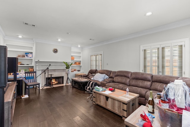 548 Cascade St, Bellaire, TX 77401 - living room with crown molding, dark wood finished floors, a high end fireplace, built in shelves, and recessed lighting