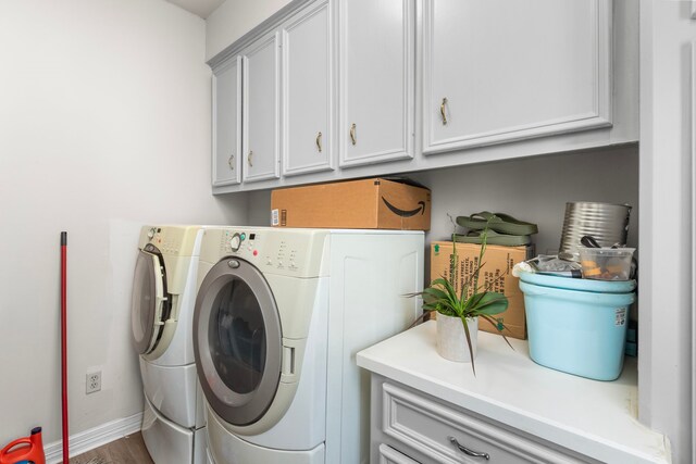 548 Cascade St, Bellaire, TX 77401 - laundry room with cabinet space, independent washer and dryer, baseboards, and wood finished floors