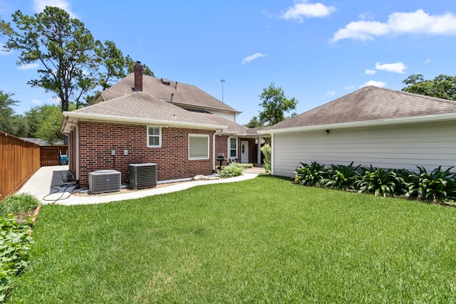 548 Cascade St, Bellaire, TX 77401 - back of house with cooling unit, a chimney, a shingled roof, and brick siding