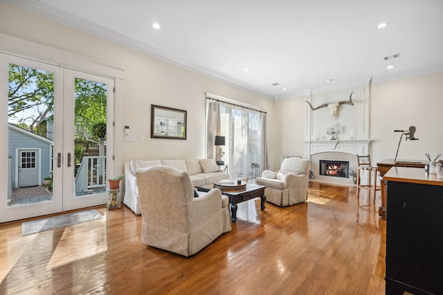 940 Columbia St, Houston, TX 77008 - living area featuring light wood-style floors, a fireplace, recessed lighting, french doors, and ornamental molding
