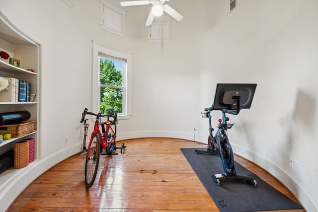 940 Columbia St, Houston, TX 77008 - workout area featuring hardwood / wood-style flooring, a ceiling fan, a high ceiling, and baseboards