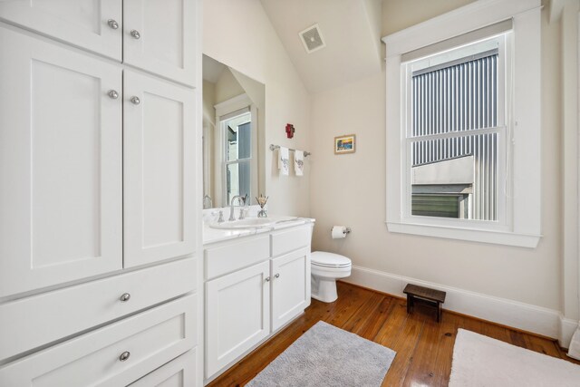 940 Columbia St, Houston, TX 77008 - bathroom with baseboards, toilet, hardwood / wood-style flooring, and vanity