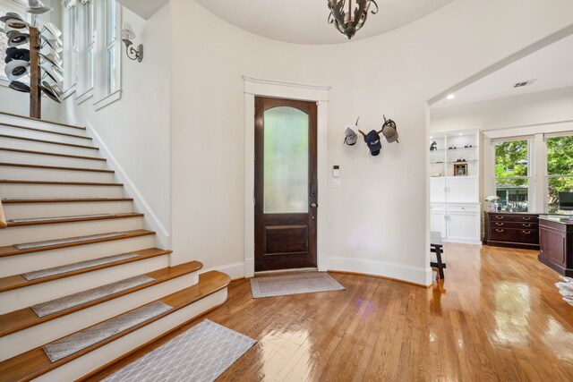 940 Columbia St, Houston, TX 77008 - entryway featuring light wood finished floors, stairs, baseboards, and a chandelier