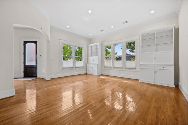 940 Columbia St, Houston, TX 77008 - unfurnished living room featuring ornamental molding, light wood finished floors, baseboards, recessed lighting, and arched walkways