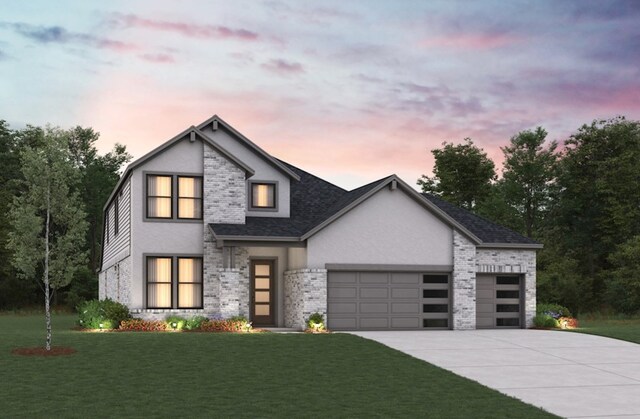 19318 Stagecoach Breeze Ln, Tomball, TX 77377 - view of front of home featuring a garage, concrete driveway, a lawn, stucco siding, and brick siding