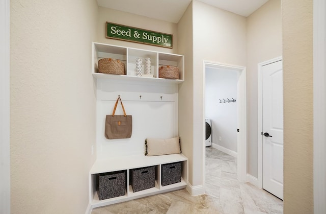 19318 Stagecoach Breeze Ln, Tomball, TX 77377 - mudroom with marble finish flooring, washer / clothes dryer, and baseboards