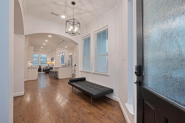 1035 Herkimer St, Houston, TX 77008 - foyer featuring a chandelier, arched walkways, ornamental molding, dark wood-style flooring, and recessed lighting