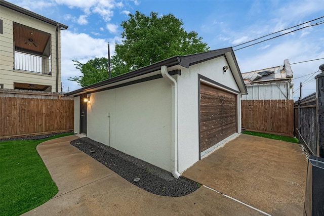 1035 Herkimer St, Houston, TX 77008 - view of property exterior with an outbuilding, concrete driveway, stucco siding, and a detached garage