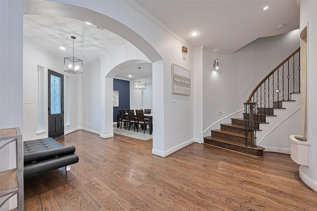 1035 Herkimer St, Houston, TX 77008 - foyer entrance with a chandelier, wood finished floors, arched walkways, recessed lighting, and stairs