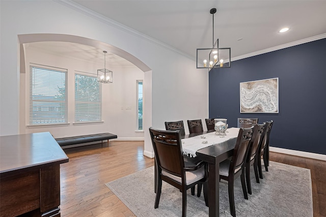 1035 Herkimer St, Houston, TX 77008 - dining room with a chandelier, arched walkways, crown molding, baseboards, and wood finished floors