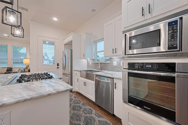 1035 Herkimer St, Houston, TX 77008 - kitchen with stainless steel appliances, a sink, white cabinetry, dark wood-style floors, and light stone countertops