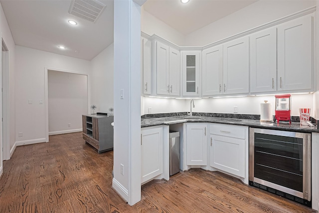 1035 Herkimer St, Houston, TX 77008 - kitchen featuring beverage cooler, white cabinetry, dark wood-style flooring, a sink, and recessed lighting