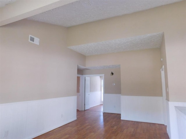17002 Rippling Mill Dr, Sugar Land, TX 77498 - spare room with wainscoting, wood finished floors, and a textured ceiling