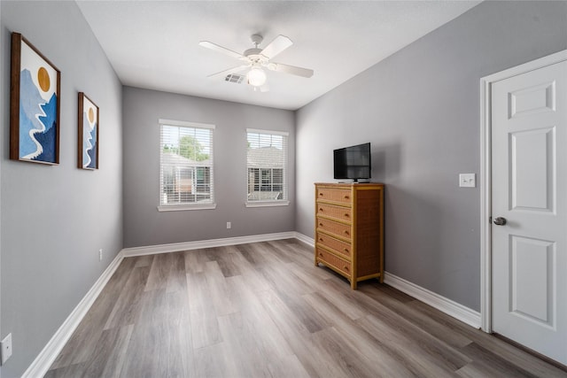 14619 Sanour Dr, Houston, TX 77084 - unfurnished bedroom with wood finished floors, baseboards, and a ceiling fan