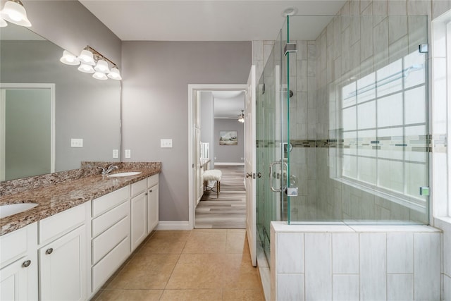 14619 Sanour Dr, Houston, TX 77084 - ensuite bathroom featuring double vanity, a shower stall, tile patterned floors, and baseboards