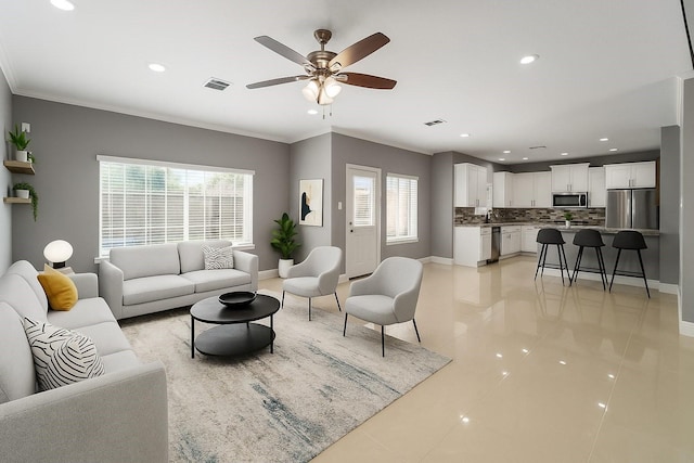 14619 Sanour Dr, Houston, TX 77084 - living area with baseboards, light tile patterned floors, ceiling fan, recessed lighting, and crown molding