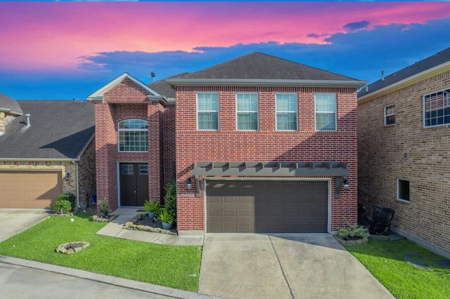 14619 Sanour Dr, Houston, TX 77084 - view of front of home with driveway, brick siding, a lawn, roof with shingles, and an attached garage