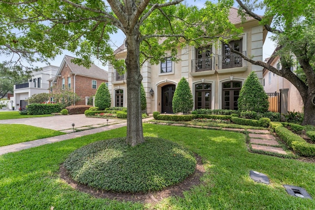 4922 Linden St, Bellaire, TX 77401 - view of front of house featuring a balcony and a front yard