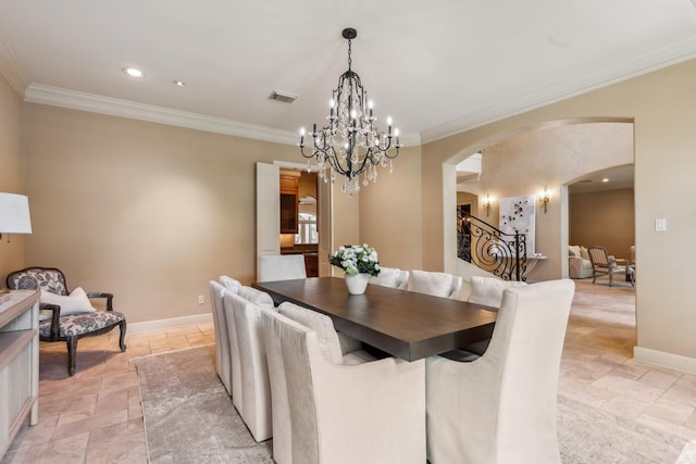 4922 Linden St, Bellaire, TX 77401 - dining area featuring stone tile flooring, arched walkways, ornamental molding, a chandelier, and baseboards