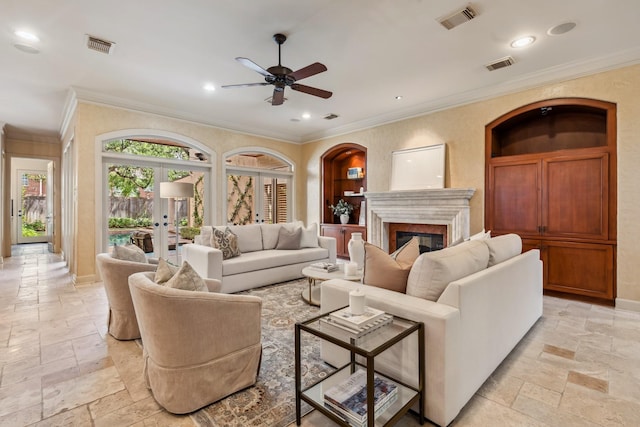 4922 Linden St, Bellaire, TX 77401 - living area featuring stone tile floors, ceiling fan, ornamental molding, a glass covered fireplace, and recessed lighting