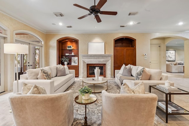 4922 Linden St, Bellaire, TX 77401 - living area featuring ornamental molding, ceiling fan, built in features, arched walkways, and a premium fireplace