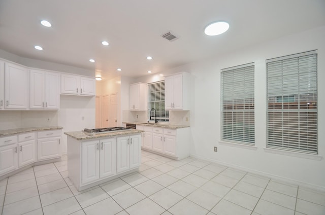 5319 Green Cove Bend Ln, Houston, TX 77041 - kitchen featuring stainless steel gas stovetop, white cabinets, light stone counters, light tile patterned floors, and recessed lighting