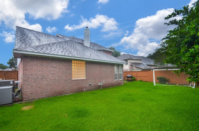 5319 Green Cove Bend Ln, Houston, TX 77041 - rear view of house featuring brick siding, a shingled roof, and a chimney