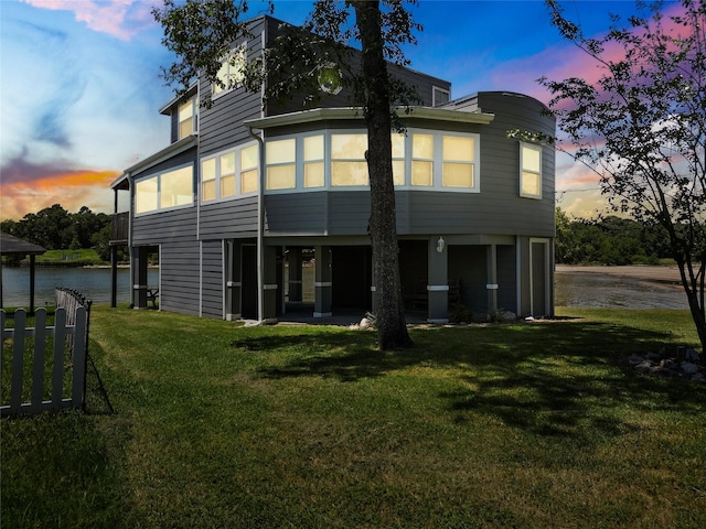210 W Lakeview, Onalaska, TX 77360 - back of house at dusk with a yard and a water view