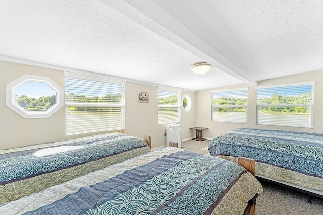 210 W Lakeview, Onalaska, TX 77360 - carpeted bedroom featuring a textured ceiling and baseboards