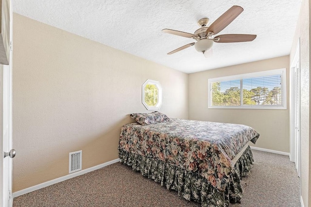 210 W Lakeview, Onalaska, TX 77360 - bedroom with carpet, baseboards, a textured ceiling, and a ceiling fan