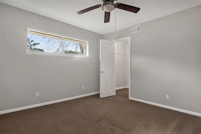 18230 Caprice Ln, Houston, TX 77058 - unfurnished bedroom with dark colored carpet, baseboards, and ceiling fan