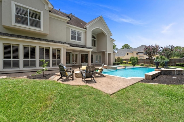 15222 Hilltop View Dr, Cypress, TX 77429 - view of pool with french doors, a pool with connected hot tub, a patio area, and a fenced backyard