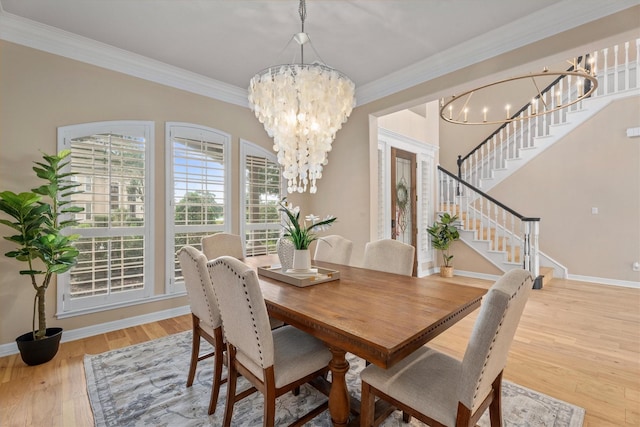 15222 Hilltop View Dr, Cypress, TX 77429 - dining space with a chandelier, ornamental molding, light wood-type flooring, and stairs
