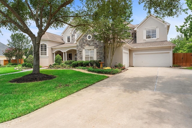 15222 Hilltop View Dr, Cypress, TX 77429 - traditional home with concrete driveway, a garage, stucco siding, and stone siding