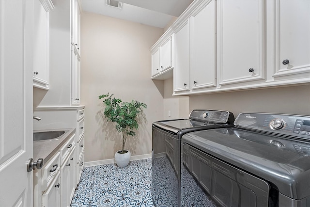 15222 Hilltop View Dr, Cypress, TX 77429 - laundry area with washing machine and clothes dryer, cabinet space, and light tile patterned floors